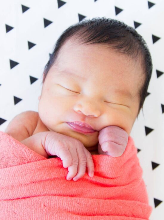 baby-ella-on-triangle-crib-sheet