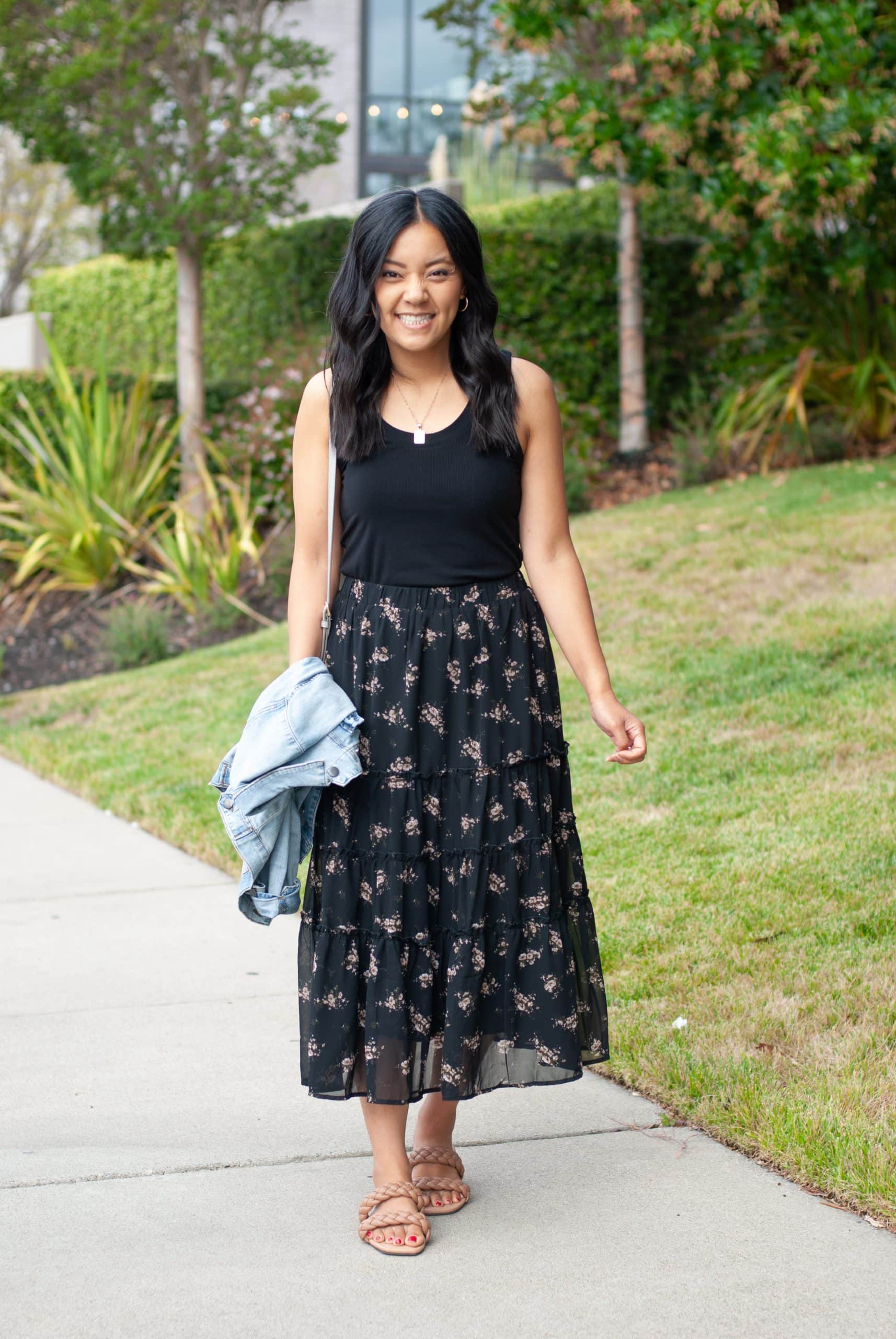 black top + black floral skirt + denim jacket + tan sandals + gold earrings + gold necklace