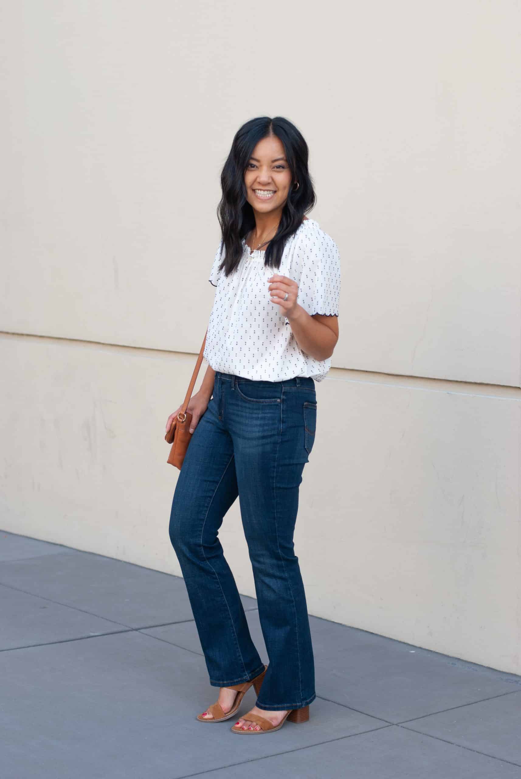 white and navy printed top + bootcut denim jeans + cognac sandals + cognac bag + gold hoop earrings + gold necklace