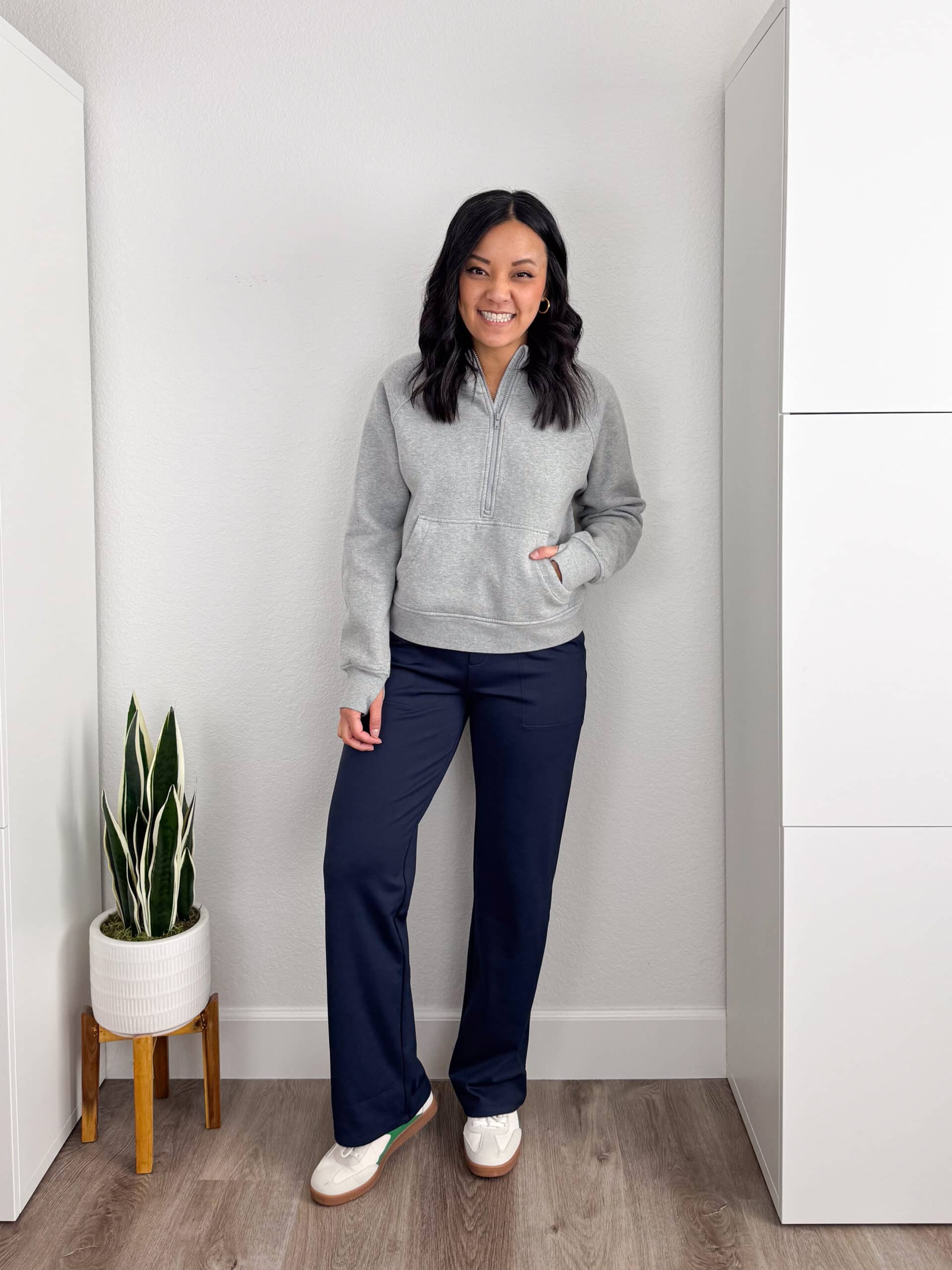 gray sweatshirt + navy blue athleisure pants + gold hoop earrings + white sneakers gray quarter zip sweatshirt + navy blue wide leg athletic pants + gold hoop earrings + white sneakers