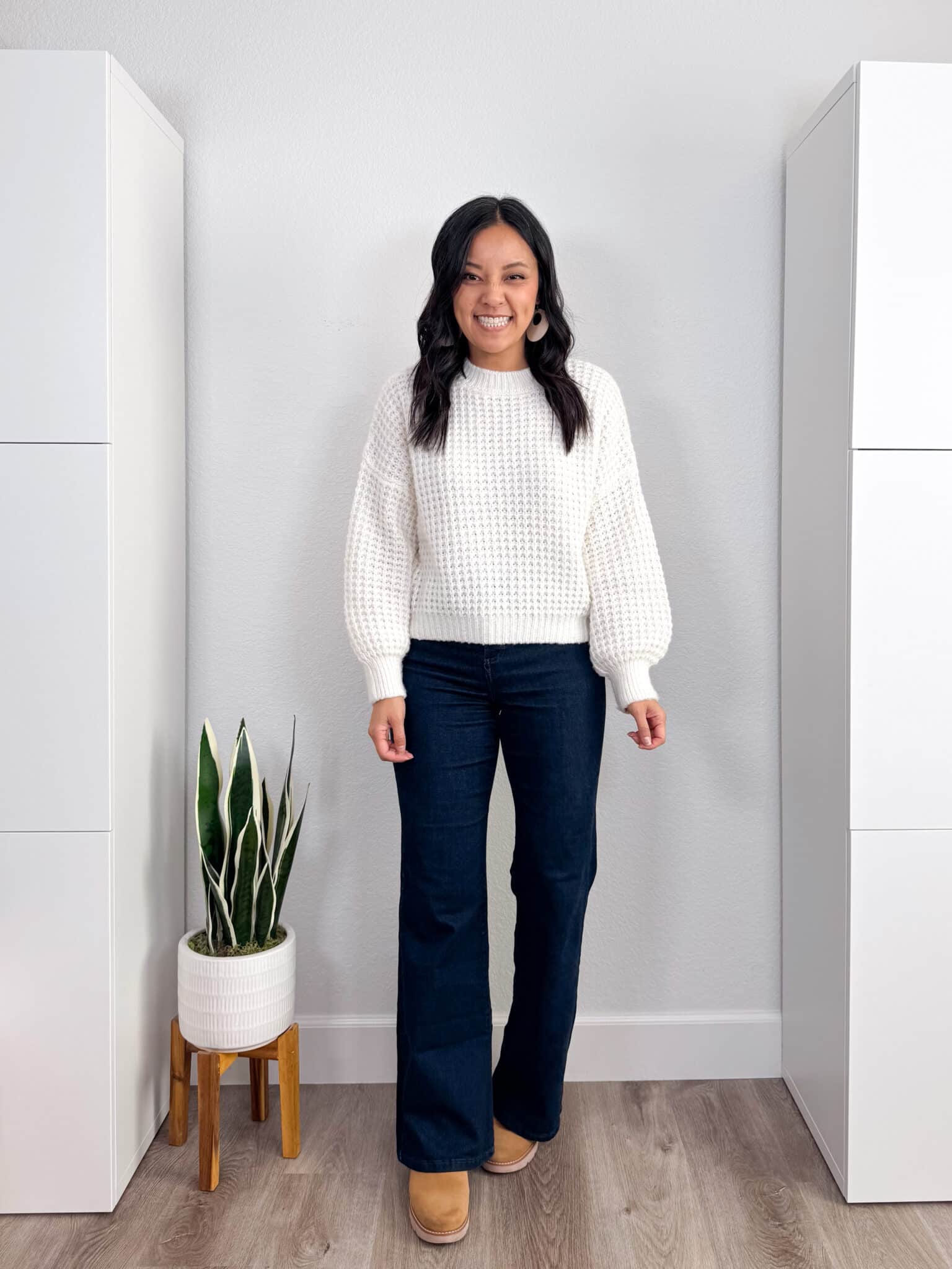 elevated casual flare jeans outfit: white waffle textured sweater, dark wash flare jeans, tan lug sole boots