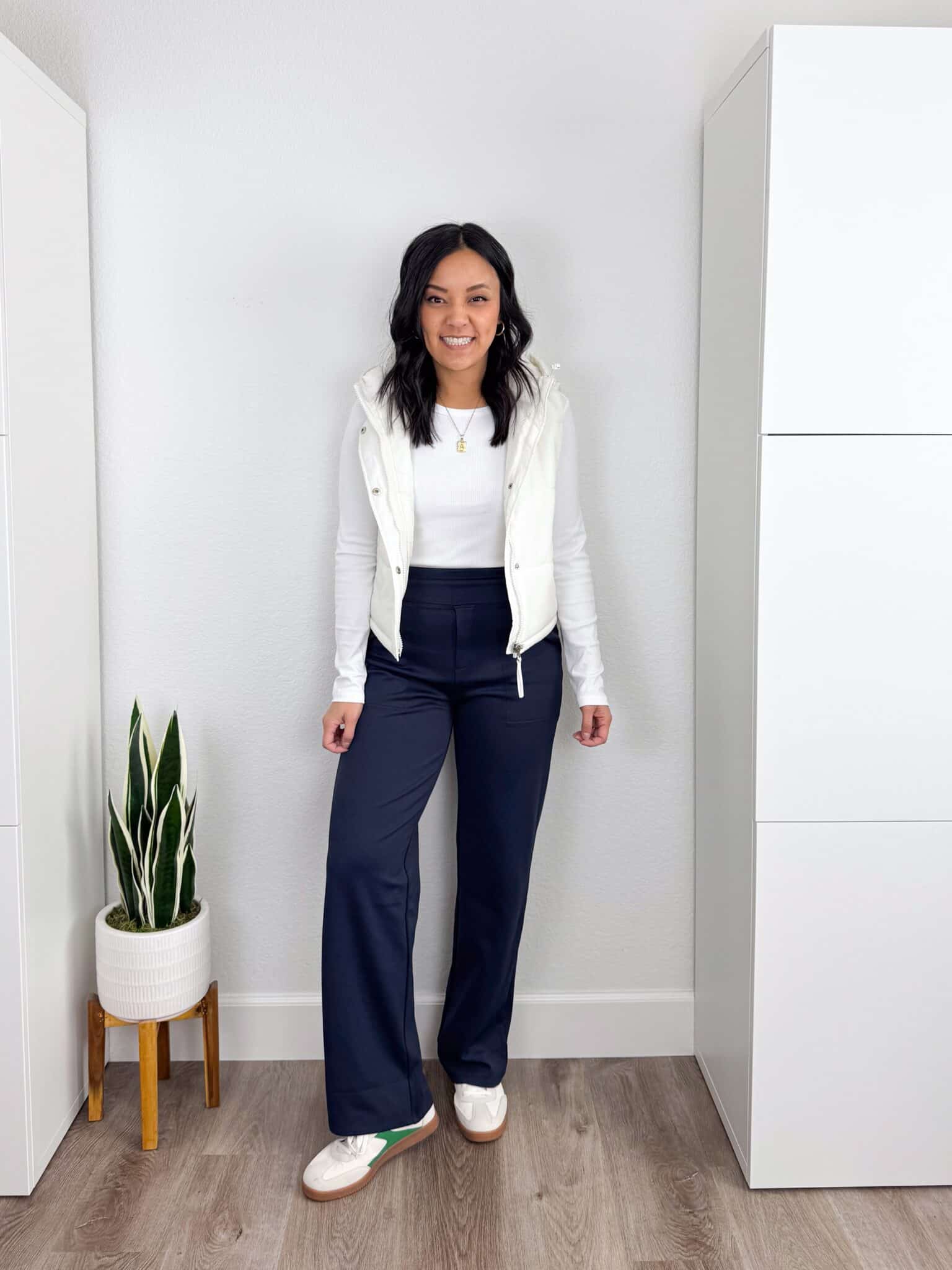 11 Wardrobe Essentials for Women Over 40 The Key Pieces That Make Looking Polished Easy + wardrobe essentials for women over 40 + putting me together + white long sleeve tee + white puffer vest + soft navy blue fleece lined sporty pants + affordable white and green sneakers 