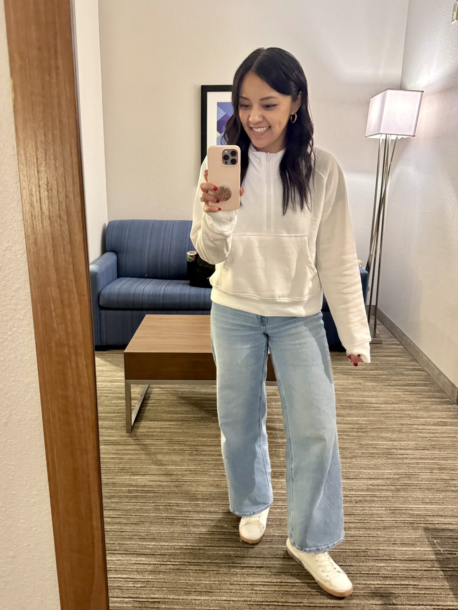11 Wardrobe Essentials for Women Over 40 The Key Pieces That Make Looking Polished Easy + wardrobe essentials for women over 40 + putting me together + white pullover sweatshirt + lightwash jeans + versatile white lifestyle sneakers