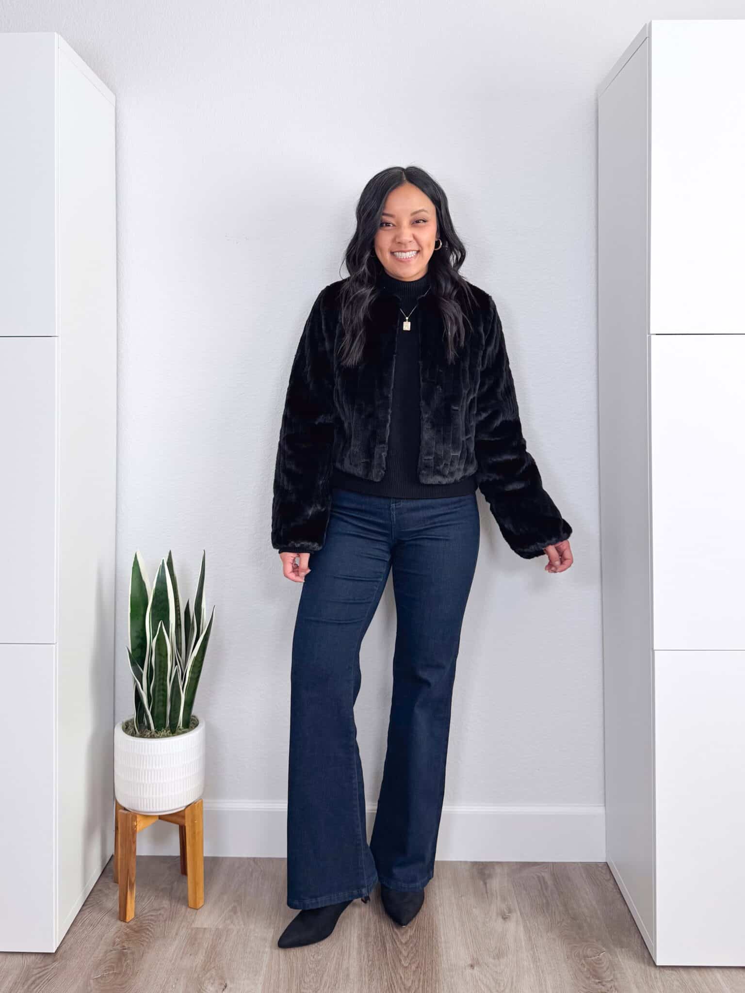 black sweater outfit ideas + putting me together + 10 Black Sweater Outfit Ideas You Can Easily Copy for Winter + versatile black sweater + comfortable flare leg dark wash jeans + black faux fur jacket + black kitten heel boots