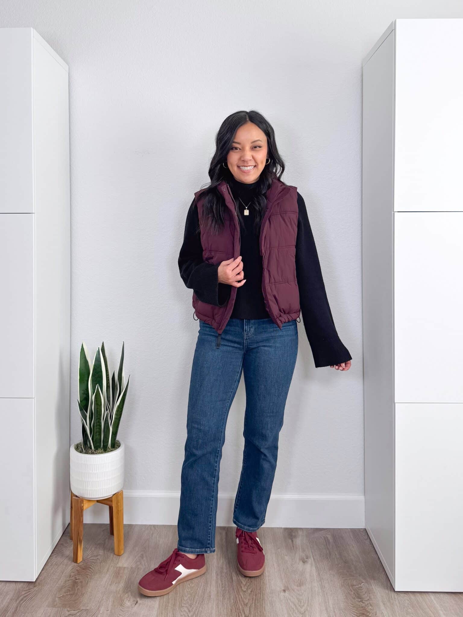 black sweater outfit ideas + putting me together + 10 Black Sweater Outfit Ideas You Can Easily Copy for Winter + versatile black sweater + cozy burgundy puffer vest + comfortable straight leg jeans + affordable burgundy sneakers