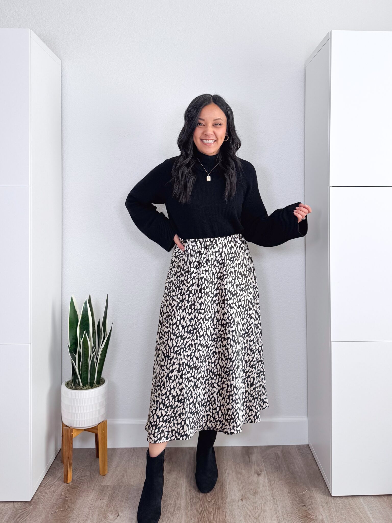 black sweater outfit ideas + putting me together + 10 Black Sweater Outfit Ideas You Can Easily Copy for Winter + versatile black sweater + black and white printed skirt + dressy black boots