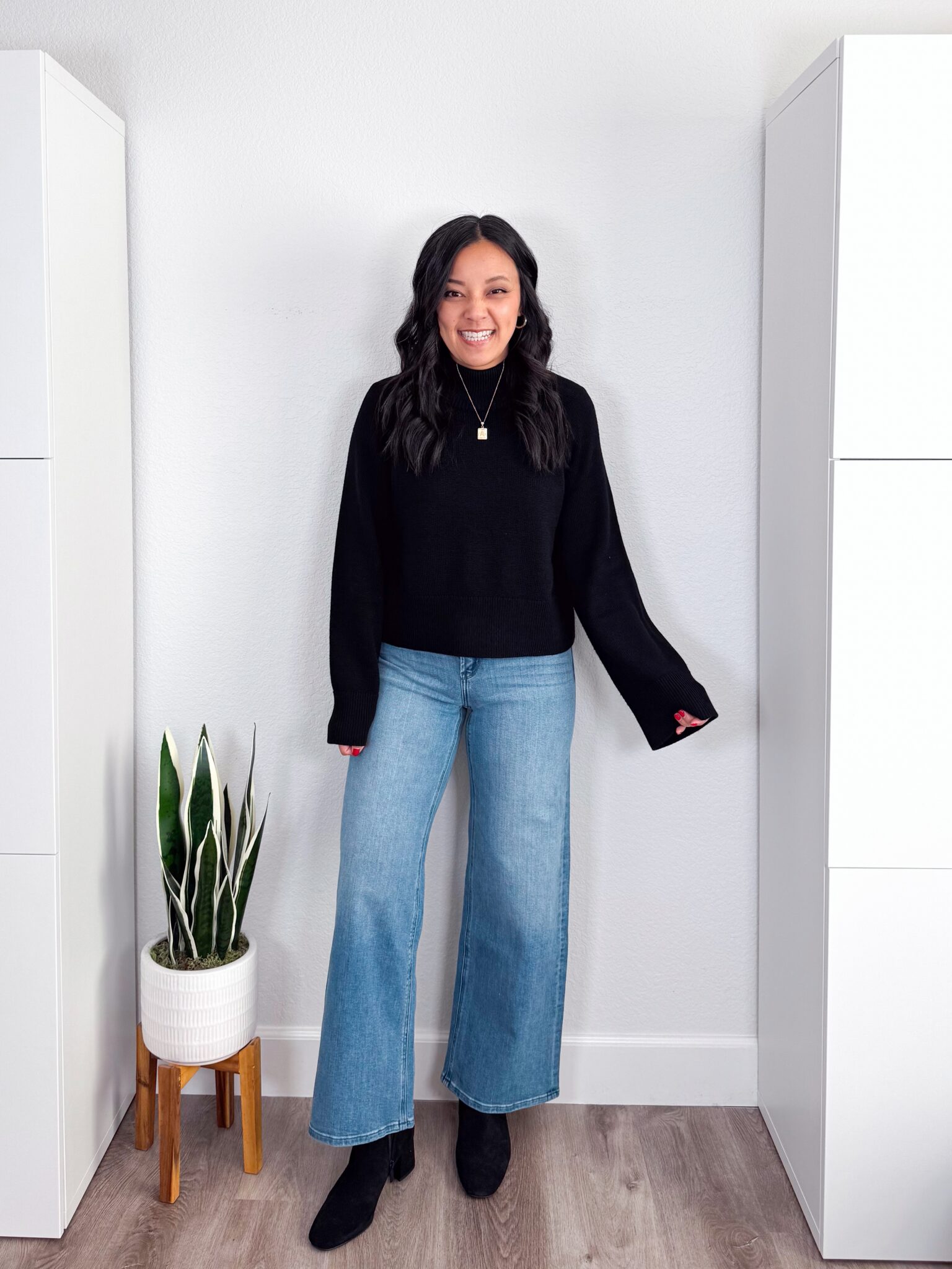 black sweater outfit ideas + putting me together + 10 Black Sweater Outfit Ideas You Can Easily Copy for Winter + versatile black sweater + comfortable wide leg jeans + water resistant black suede boots