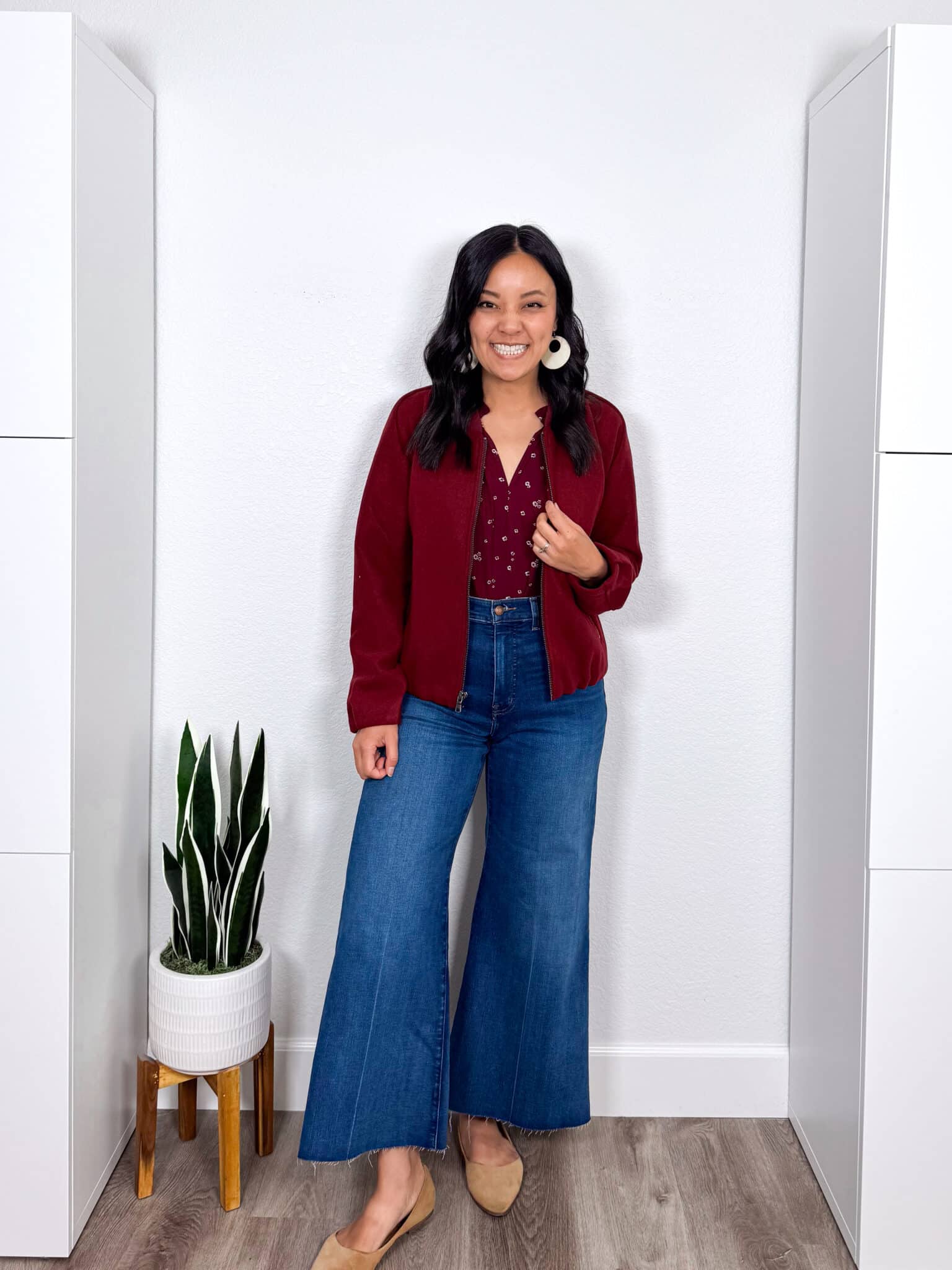 how to dress for spring when it's still cold + putting me together + dress for spring when it's cold + burgundy floral top + burgundy bomber jacket + comfortable flare jeans + tan flats