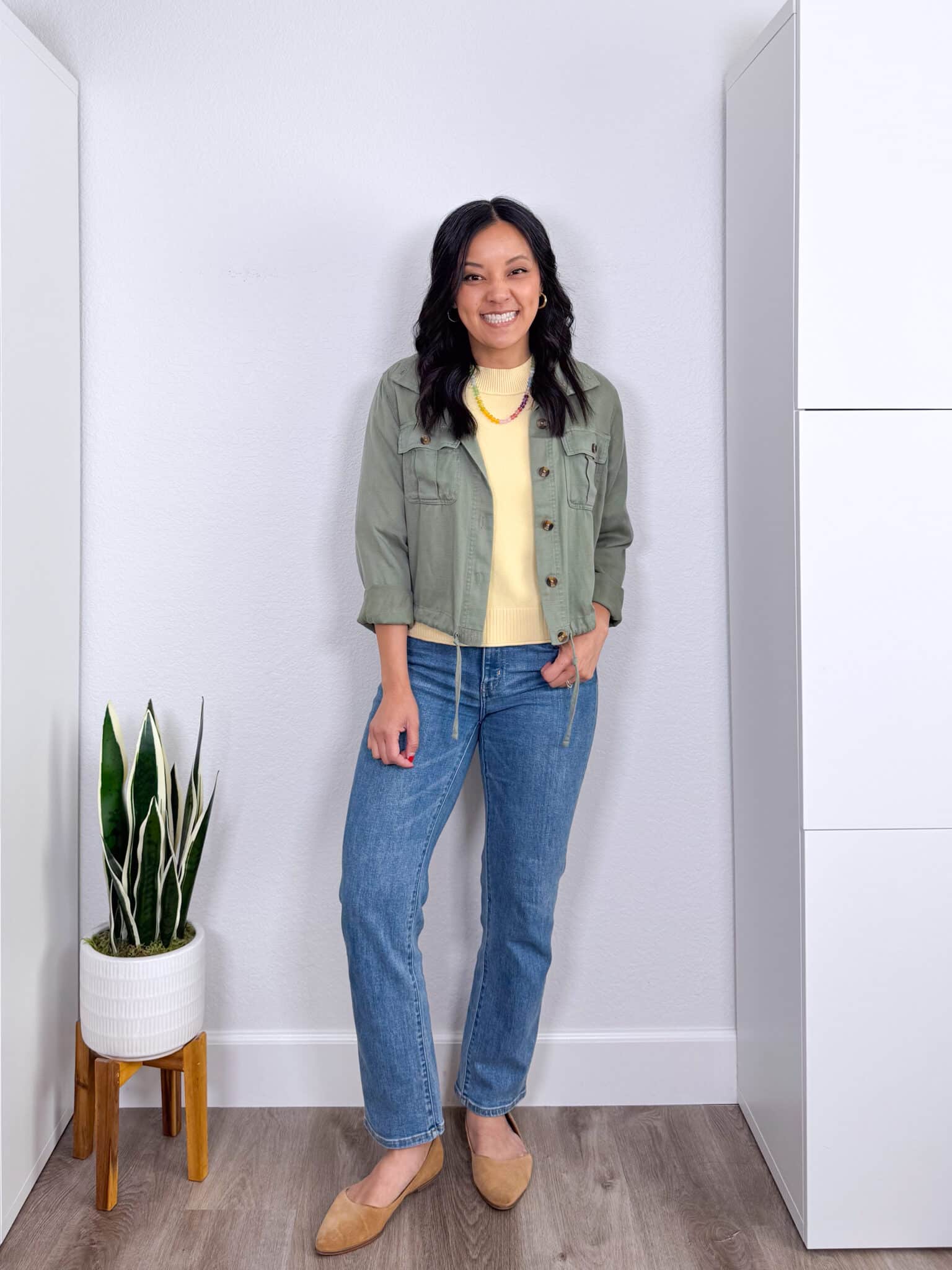 What Color Goes With Butter Yellow? Easy Outfit Ideas + what color goes with butter yellow + putting me together + soft butter yellow short sleeve sweater + comfortable medium wash straight leg jeans + tan flats + light olive green utility jacket + gold hoop earrings + affordable colored beaded necklace
