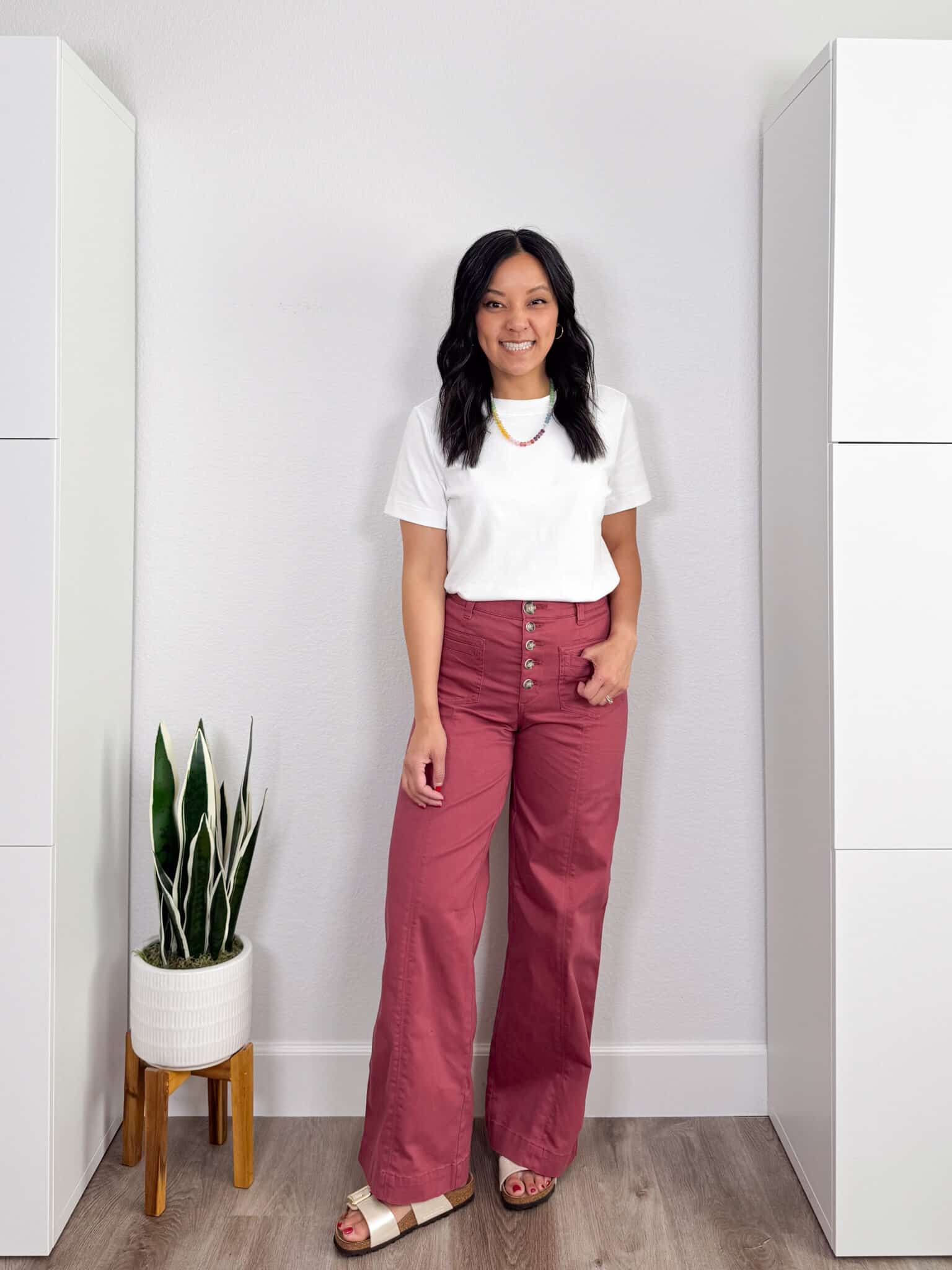 My BEST Pants Recommendations for Spring & Summer + best pants for spring & summer + My BEST Pants for Spring & Summer That You'll Want to Live In + putting me together + versatile white t-shirt + pink comfortable wide leg jeans + metallic ivory sandals + gold hoop earrings + colorful beaded necklace