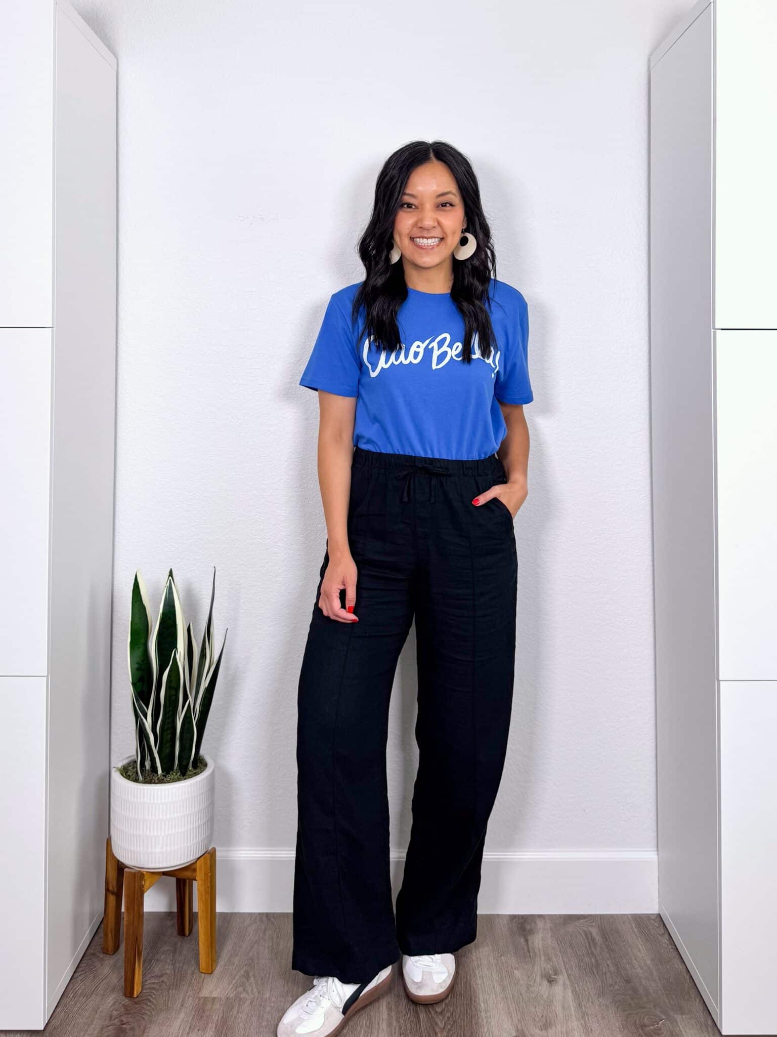 What to Wear With Black Linen Pants: 14 Outfit Ideas for Summer You Can Easily Copy + black linen pants outfit + putting me together + blue graphic tee + black wide leg linen pants + comfortable white and black sneakers + lightweight white earrings