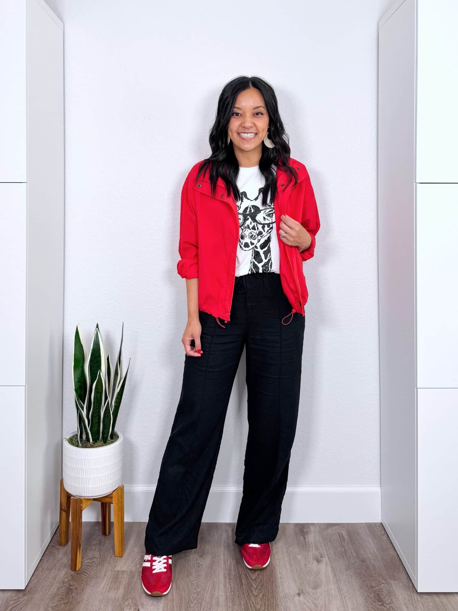 What to Wear With Black Linen Pants: 14 Outfit Ideas for Summer You Can Easily Copy + black linen pants outfit + putting me together + black and white giraffe graphic tee + black wide leg linen pants + red bomber jacket + fun red sneakers + lightweight white earrings