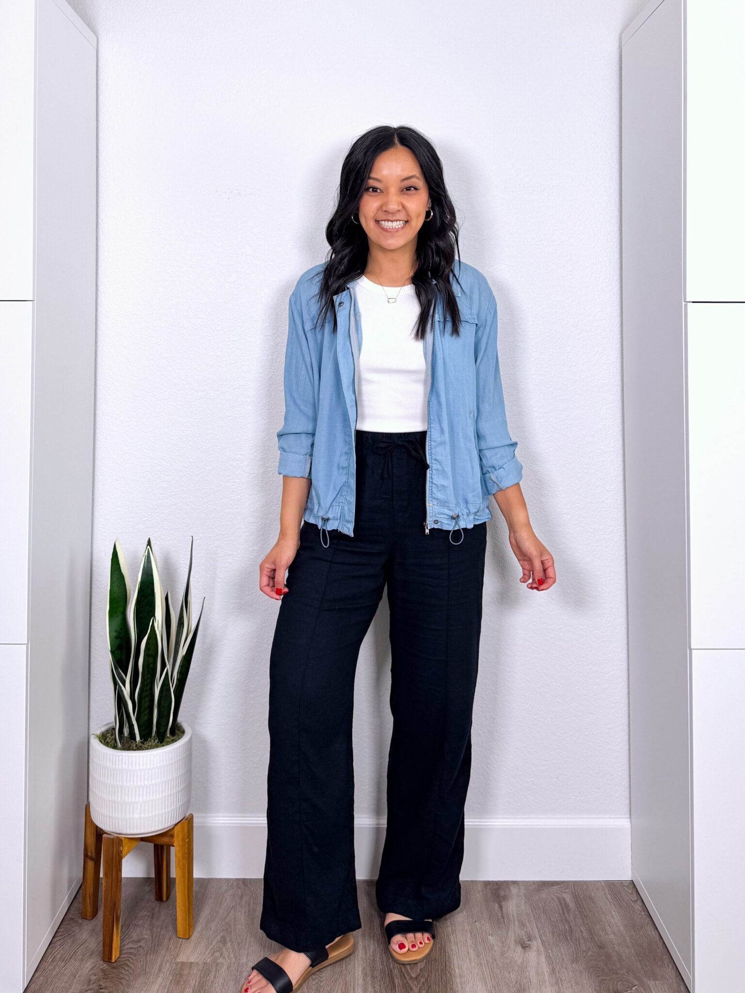 What to Wear With Black Linen Pants: 14 Outfit Ideas for Summer You Can Easily Copy + black linen pants outfit + putting me together + versatile white tank + black wide leg linen pants + lightweight denim jacket + black sandals + gold jewelry